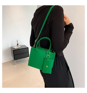 Detailed back view of a green quilted PU handbag set with an adjustable shoulder strap