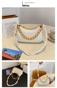 Detail of white snake-embossed leather hobo bag with gold chain and iridescent finish