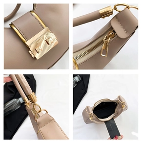 Close-up of golden hardware lock and high-quality zipper details on earth-tone crescent bag