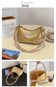 Detail of gradient gold handbag with lizard texture, thick chain, and knotted shoulder strap
