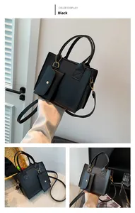 Detail of black quilted tote bag with gold hardware and matching coin purse pendant