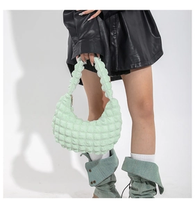 Pale green hobo bag with pleated bubble texture shown on model for casual commuting