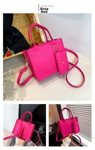 Detail of fuchsia quilted crossbody bag featuring stitch pattern and matching mini pouch