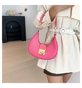 Detail of vibrant hobo bag featuring crescent shape and elegant gold metallic buckle lock