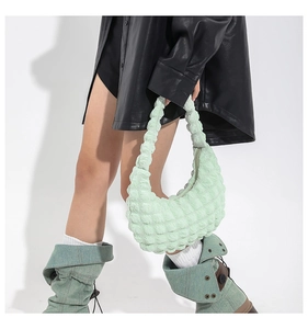 Detail of mint green quilted hobo bag featuring a unique bubble texture and soft design