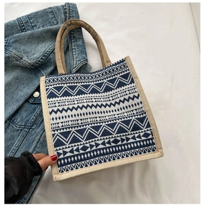 Detailed close-up of small ethnic tote bag featuring blue geometric patterns and jute texture