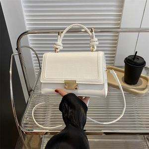 White faux crocodile skin crossbody bag with gold hardware and knotted top handle