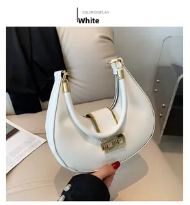 Detailed view of white crescent-shaped PU leather handbag with gold metal clasp