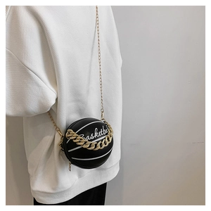 Detail of basketball shaped PU crossbody bag with gold chain strap and white lettering