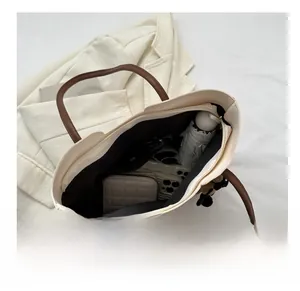 Vista dall'alto dell'interno della borsa tote beige con grande capacità e manici