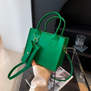 Green quilted handbag with matching mini purse and adjustable crossbody strap