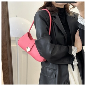 Pink hobo bag with a gold heart-shaped metal buckle and matte leather texture