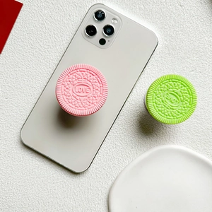 Detail shot of biscuit-shaped phone sockets in pink and green with Love engraving