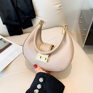 Minimalist beige crescent shoulder bag with gold hardware for daily elegant commute