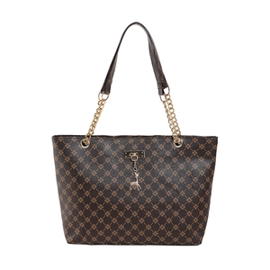 Brown vintage tote bag with gold floral monogram, leather strap, and deer pendant
