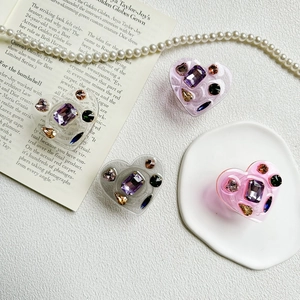 Luxurious heart-shaped phone socket grip with sparkling rhinestones and gems in multiple colors
