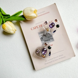 Detail of luxury heart-shaped phone grip with colorful rhinestones and gemstone inlays