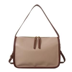 Minimalist beige tote bag with dark brown contrast piping and gold-tone metal hardware