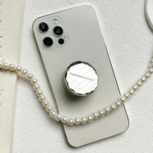 Silver diamond-cut mirror phone grip tok stand on white smartphone with pearl necklace