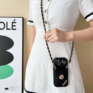 Quilted iPhone case with metal buckle, chain strap, and bow detail shown on a model