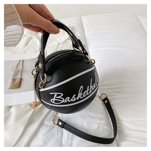 Close-up of a basketball-shaped handbag with litchi texture and gold chain strap