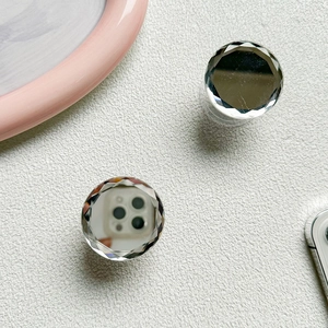 Macro shot of phone grip featuring multifaceted crystal edges and a built-in makeup mirror