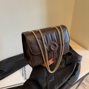 Deep brown quilted crossbody bag with gold chain strap and circular metal lock buckle