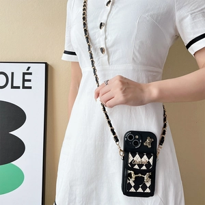 Black and white quilted leather crossbody wallet phone case with gold bear and chain strap