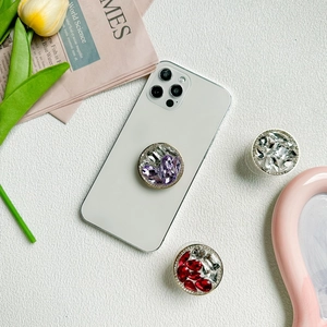 Support de téléphone luxueux avec strass sur fond élégant en cuir blanc texturé