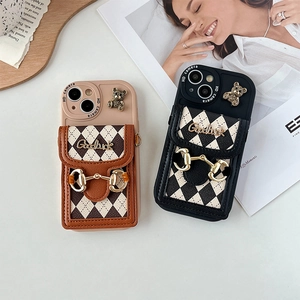Detail of crossbody phone case with quilted card holder and metal bear ornament
