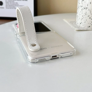 Detail of transparent foldable phone case with white leather wrist strap and metal studs