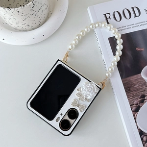 Foldable phone case detail with resin roses, crystal butterflies and pearl strap