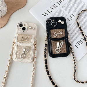 Close-up of woven texture iPhone case with rhinestone Smile lettering and rabbit charm