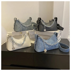 Collection of crescent underarm bags with thick silver chains in leather and denim fabrics
