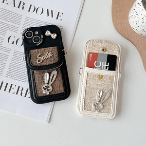 Detail view of tweed wallet phone cases with rhinestone bunny and card slots for iPhone