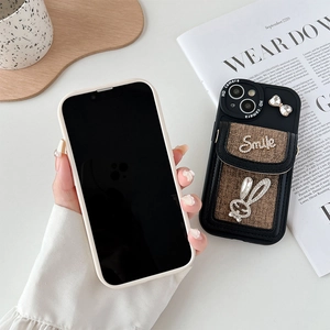 Detail of iPhone wallet case with brown textured fabric and rhinestone bunny ornament