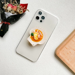 Creative 3D food-shaped scallop phone socket mount on a minimalist smartphone case