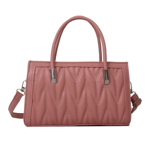 Pink faux leather tote bag with vertical diamond stitching and top handles