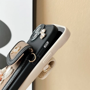 Detail of luxury iPhone case with rhinestone heart and leather wallet card holder