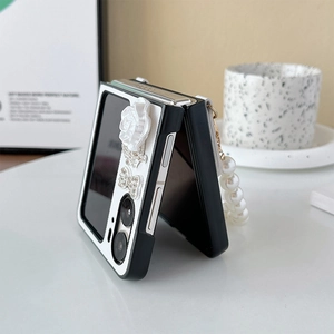Detail of floral flip case with rhinestone bow and pearl handle for folding phone