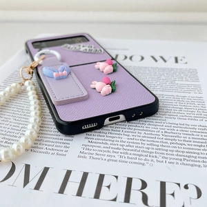 Detail of purple leather Z Flip case with pearl strap and blue polka dot bow