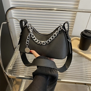 Black pebbled leather crescent underarm bag with silver chain strap and metal pendant