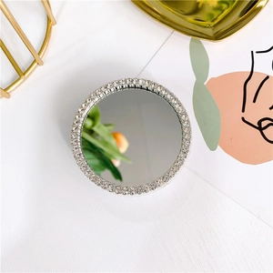 Close-up of a silver mirror phone socket featuring a sparkling rhinestone-encrusted border