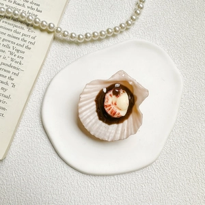 Macro shot of realistic resin scallop with shrimp topping mobile phone socket grip
