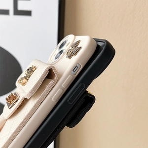 Detail view of iPhone leather case with diamond bowknot and mini wallet attachment