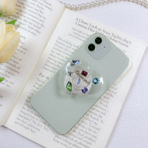 Green heart-shaped phone grip with colorful rhinestones and gold Diamonds text
