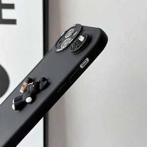 Close-up of black matte phone case featuring 3D coffee bear and Oreo biscuit detail