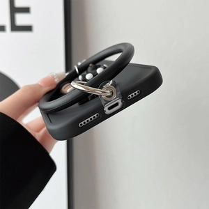 Close-up of black matte phone case with large silicone wrist strap and silver metal ring