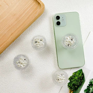 Support de téléphone scintillant avec strass et perles sur smartphone vert