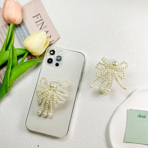 Collapsible pearl bow phone socket holder with elegant beaded design and tassel